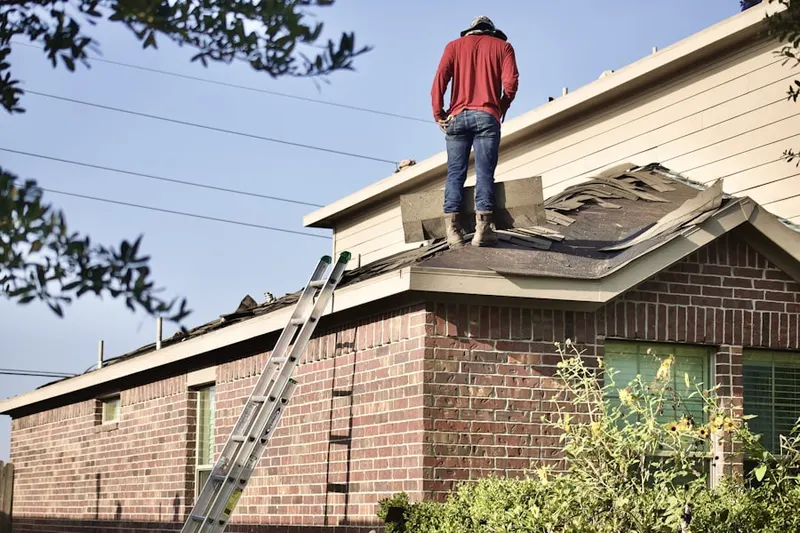 Professional roofer working on a residential roof in Holly Tree Estates